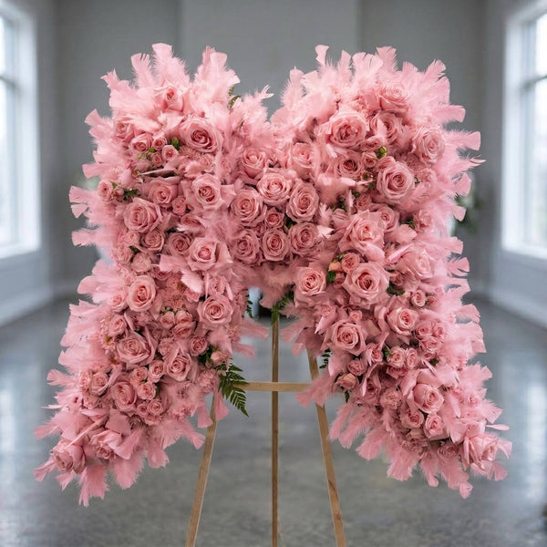 Pink angel wings sympathy standing spray with pink roses and feathers, Los Angeles funeral flower delivery