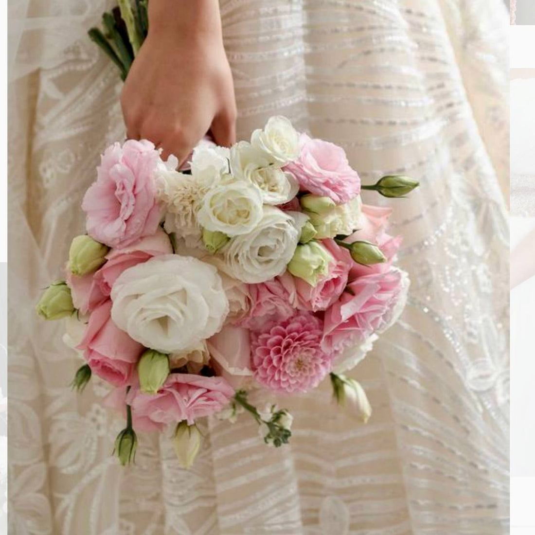 Pink and ivory bridal bouquet with lisianthus, roses, and dahlias against a lace wedding dress in Los Angeles