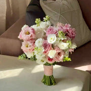 Pink and white lisianthus bridal bouquet with roses and stocks wrapped in blush ribbon in Los Angeles