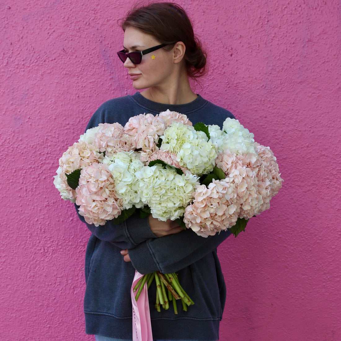 Elegant bouquet of pink roses with lush green accents, ideal for romantic celebrations