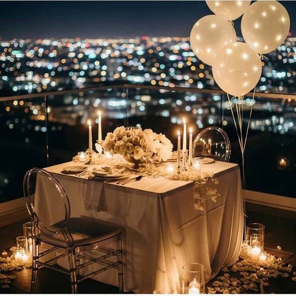 Rooftop private dinner setup with candles and balloons, Los Angeles event florist