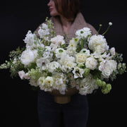 Elegant bouquet of white flowers with lush greenery, symbolizing purity and simplicity