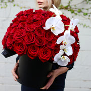 Grand luxury floral arrangement with red roses and white orchids in a premium gift-ready box