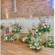 Romantic multi-level ceremony backdrop with cascading roses for Los Angeles weddings
