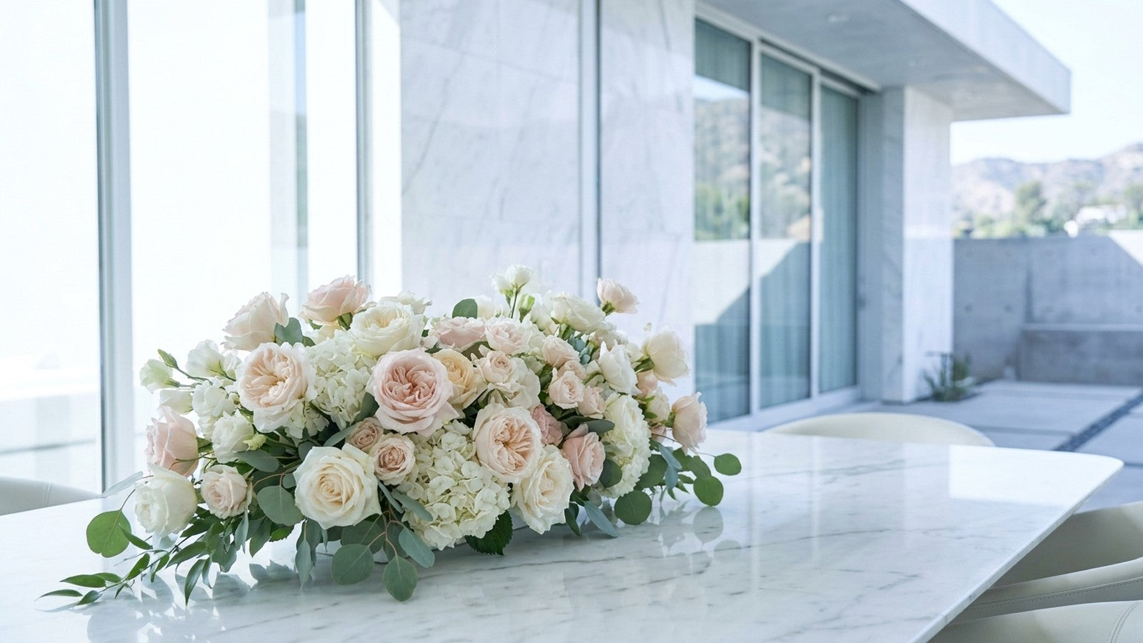 wide flower arrangement on marble in a Los Angeles home