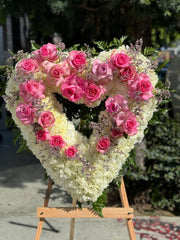 Heart-shaped sympathy bouquet with pink roses and peonies, symbolizing compassion and remembrance