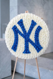 Custom team tribute funeral wreath in white chrysanthemums with team emblem on easel — Los Angeles same-day delivery, Pink Clover