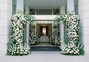 Pink Clover Grande Floral Entrance: Lush white roses, pink hydrangeas, delphinium, greenery arches. Elegant event