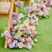 Whimsical aisle arrangement with purple alliums and sweet peas for Los Angeles weddings