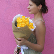 Vibrant bouquet of yellow roses with lush green accents, ideal for joyful celebrations