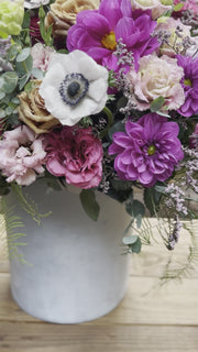Handcrafted floral composition with dramatic anemones and complementary blooms, arranged in a refined aesthetic