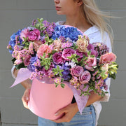Elegant Glow bouquet with pink, purple and blue flowers, beautifully styled in a keepsake box for romantic occasions