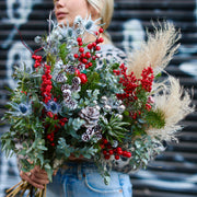Elegant Winterberry bouquet with red berries and decorative succulents, beautifully presented for pr