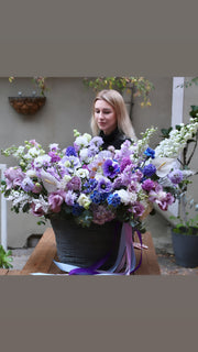 Elegant bouquet showcasing rich purple tones with fresh tulips and lavender roses, ideal for special occasions