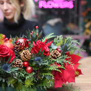 Luxurious holiday floral arrangement with white blooms and natural accents, ideal for Christmas tabl