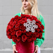 Luxurious red rose arrangement in a decorative Christmas box, ideal for holiday gifting and romantic