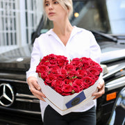 Handcrafted heart-shaped floral gift with fresh red roses, presented in a精致 decorative box for a luxurious look