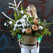 Elegant Christmas tree decorated with white roses, pinecones and festive natural accents for a luxur