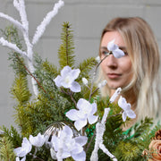 Beautifully styled holiday Christmas tree with fresh flowers and earthy accents, ideal for luxury ho