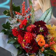 Cozy fall floral design with warm-toned blooms, presented in a soft and elegant style for seasonal gifting