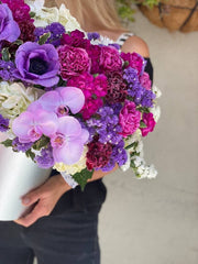 Josephine's handcrafted bouquet features fresh anemones, hydrangeas and carnations in a gift box for an elegant presentation.