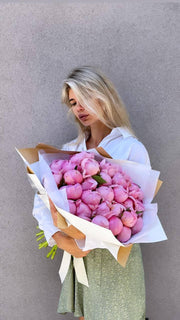 Vibrant red and pink peony arrangement showcasing fresh blooms and expert floral craftsmanship